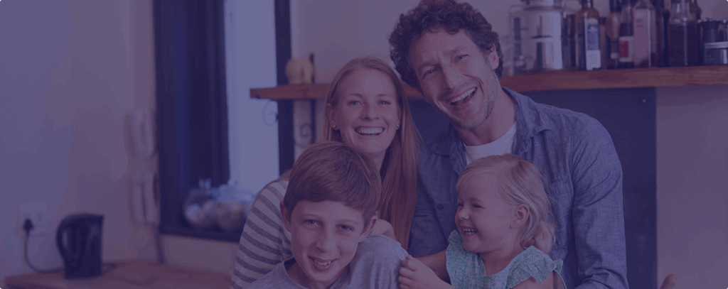 Family smiling and posing for family photograph