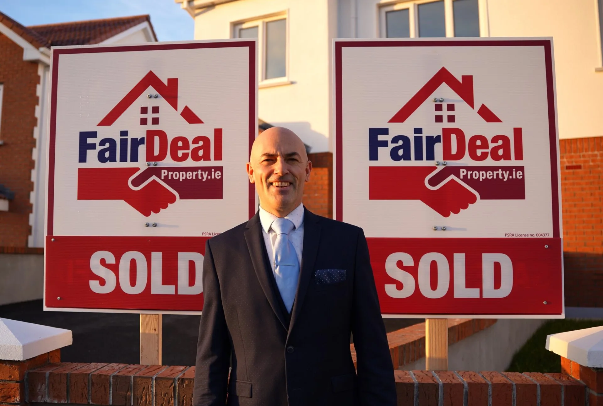 Johnny from Fair Deal Property poses with signage
